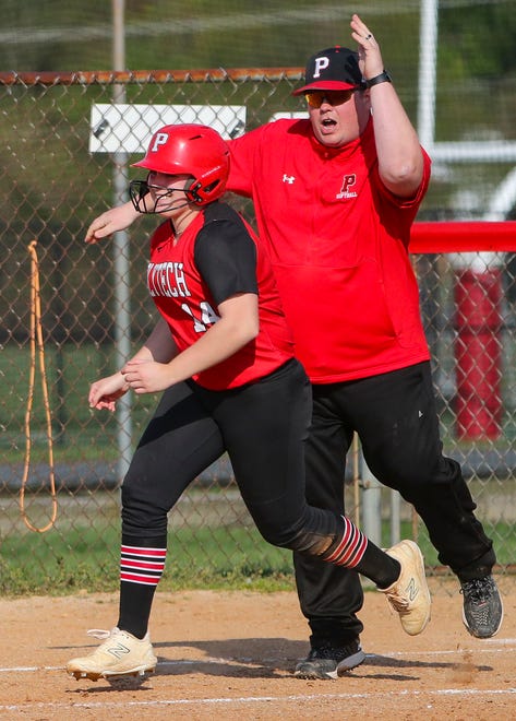Polytech head coach Kyle Taylor cheers Julia MacConnell as she heads for home on her three-run home run in the fourth inning of Polytech's 8-3 win at Smyrna High School, Thursday, April 18, 2024.