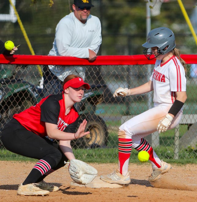 Smyrna's Kennedy Diehl pulls into third base on a RBI hit as Polytech's Gabrielle Bogdon collects a throw in the fourth inning of Polytech's 8-3 win at Smyrna High School, Thursday, April 18, 2024.