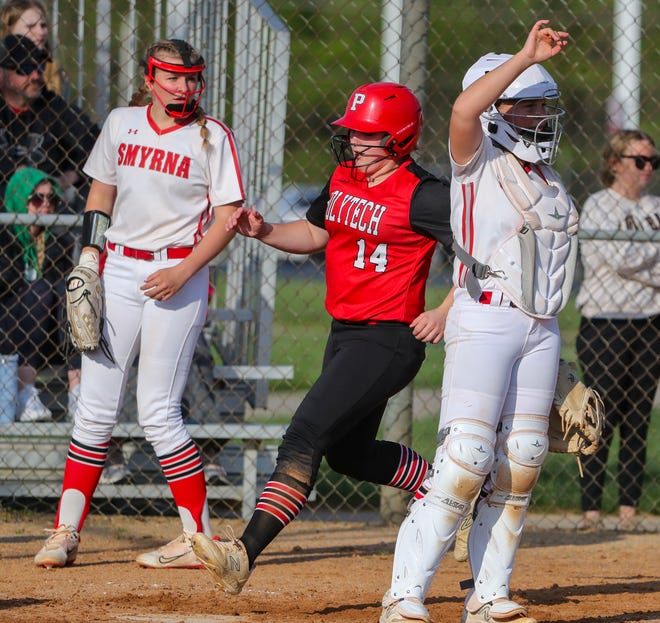 Polytech's Julia MacConnell scores between starter Alexis Dennis (left) and catcher Adison Weisenberger on Gabrielle Bogdon's two-RBI single in the sixth inning as the Panthers build their lead in Polytech's 8-3 win at Smyrna High School, Thursday, April 18, 2024.