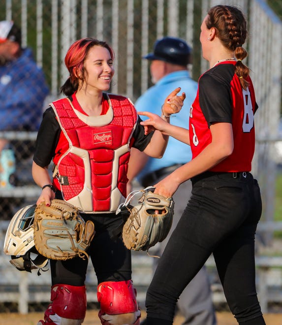 Catcher and pitcher Brianna Benton (left) and Mara Everton come together after the last out in Polytech's 8-3 win at Smyrna High School, Thursday, April 18, 2024.