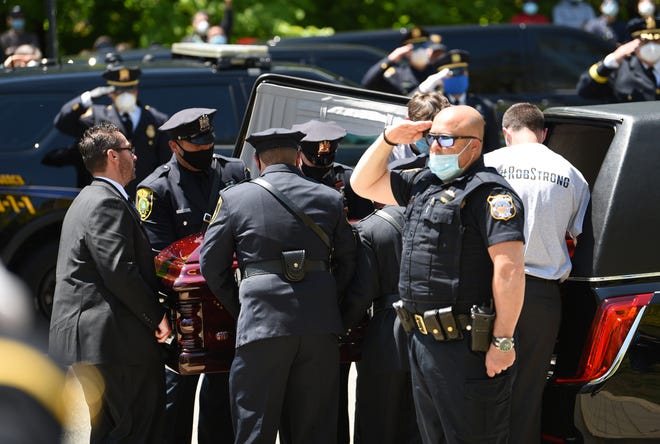 The casket of Officer Charles Edward Roberts III, who died of complications related to COVID-19 on Monday, is placed inside of the hearse following the memorial outside of the Glen Ridge Municipal Complex in Glen Ridge on 05/14/20.