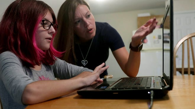 ToniAnn Brand helps her 7th grade daughter Madison, 12, participate in her first virtual Toms River Intermediate North class from their home Tuesday, September 8, 2020.