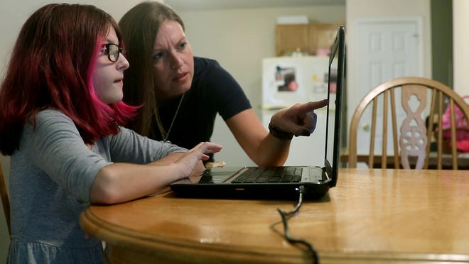 ToniAnn Brand works with her 7th grade daughter Madison, 12, during her first virtual Toms River Intermediate North class from their home Tuesday, September 8, 2020.