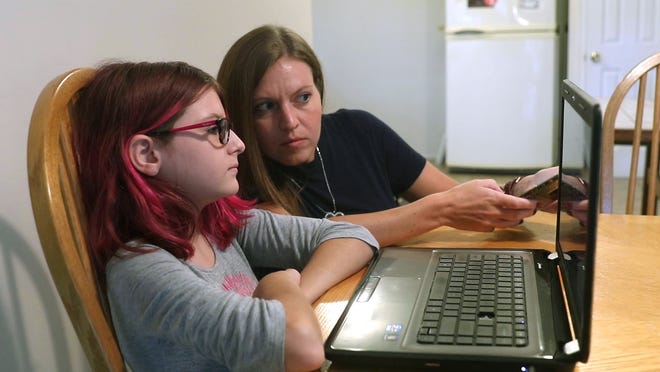 ToniAnn Brand watches as her 7th grade daughter Madison, 12, participates in her first virtual Toms River Intermediate North class from their home Tuesday, September 8, 2020.