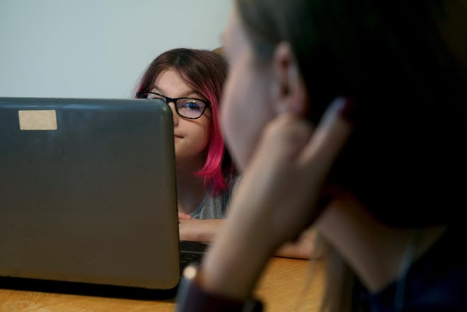 Toms River Intermediate North 7th grader Madison Brand, 12, looks over to her mother ToniAnn during her first virtual class from their home Tuesday, September 8, 2020.