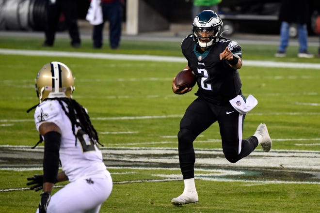 The Philadelphia Eagles' Jalen Hurts carries the ball against the New Orleans Saints on Sunday, Dec. 13, 2020, in Philadelphia.
