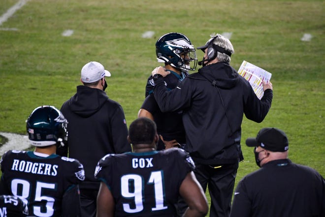 Eagles' head coach Doug Pederson, right, speaks with quarterback Jalen Hurts (2) in his first start against the Saints Sunday, Dec. 13, 2020 in Philadelphia. The Eagles won 24-21.