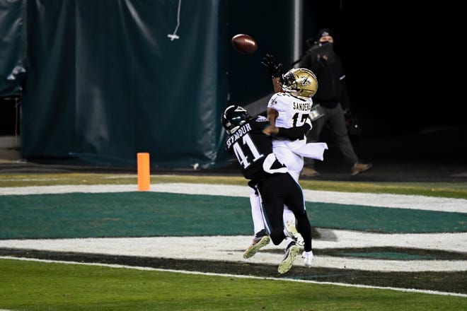 Saints' Emmanuel Sanders (17) catches a touchdown pass over Eagles' Kevon Seymour (41) Sunday, Dec. 13, 2020 in Philadelphia. The Eagles won 24-21.