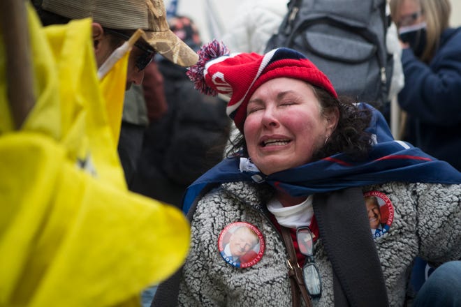 Jan 6, 2021; Washington, DC, USA;  A Trump supporter receives aid after tear gas was deployed at rioters storming the U.S. Capitol Wednesday afternoon as lawmakers inside debated the certification of the presidential election.  Mandatory Credit: Jerry Habraken-USA TODAY