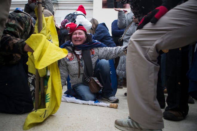 Jan 6, 2021; Washington, DC, USA;  A Trump supporter receives aid after tear gas was deployed at rioters storming the U.S. Capitol Wednesday afternoon as lawmakers inside debated the certification of the presidential election.  Mandatory Credit: Jerry Habraken-USA TODAY