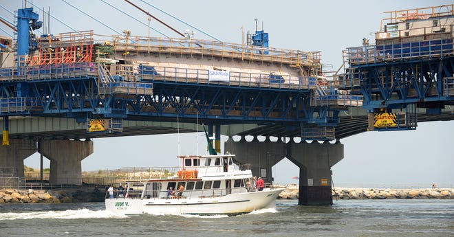 Head Boat Judy V goes out in July 2011 as bridge sections are getting closer together as construction on the Indian River Inlet Bridge.